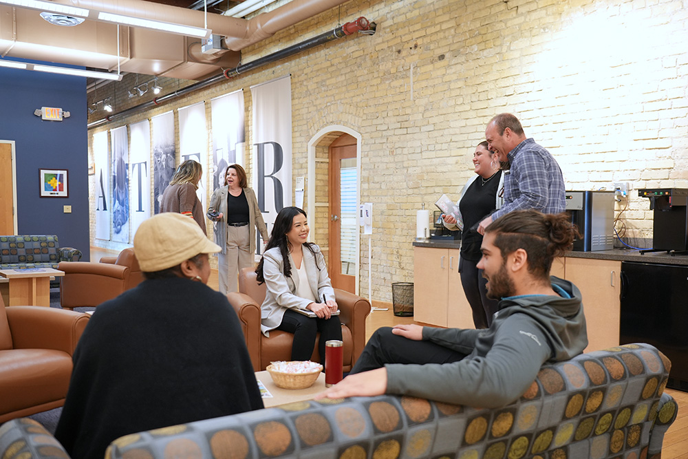 Staff members causally talking in common area